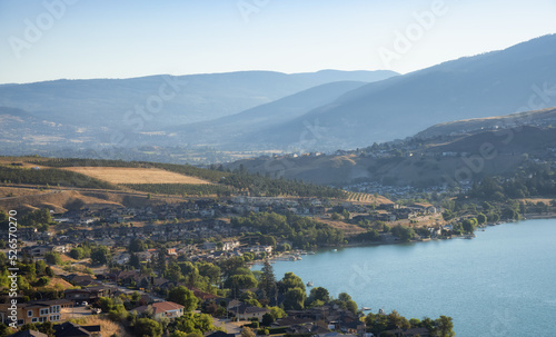 Slika na platnu Scenic View of Kalamalka Lake and a small City during sunny summer sunrise