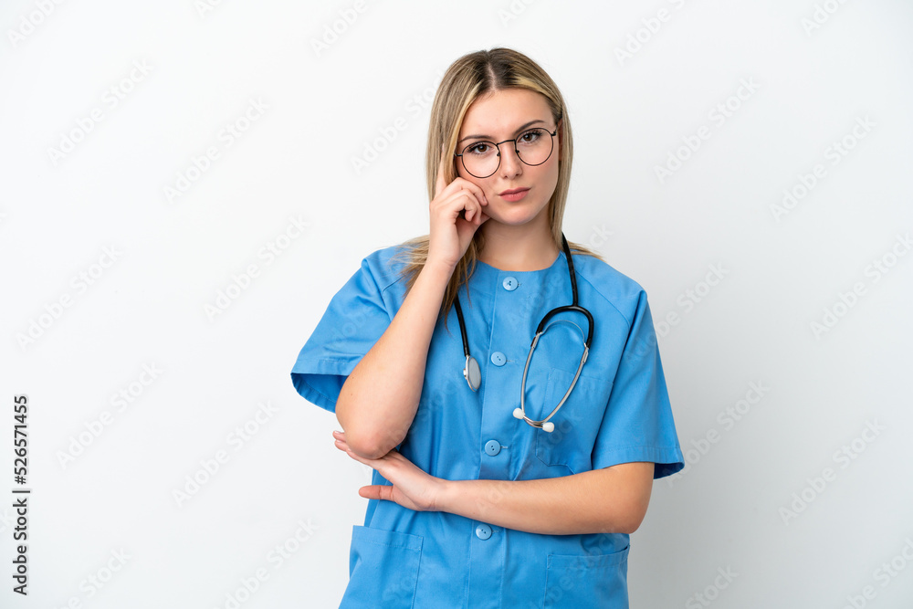 Young surgeon doctor woman isolated on white background thinking an idea Young surgeon doctor woman isolated on white background thinking an idea