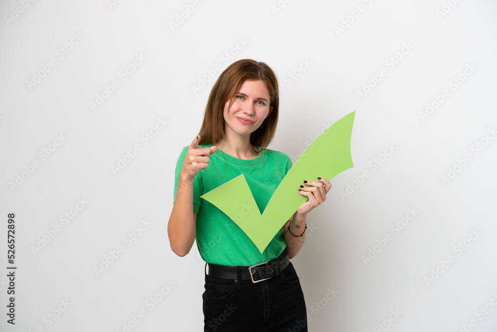 Young English woman isolated on white background holding a check icon and pointing to the front Young English woman isolated on white background holding a check icon and pointing to the front