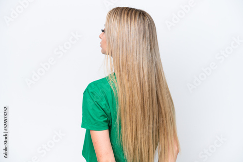 Pretty blonde woman isolated on white background in back position and looking back
