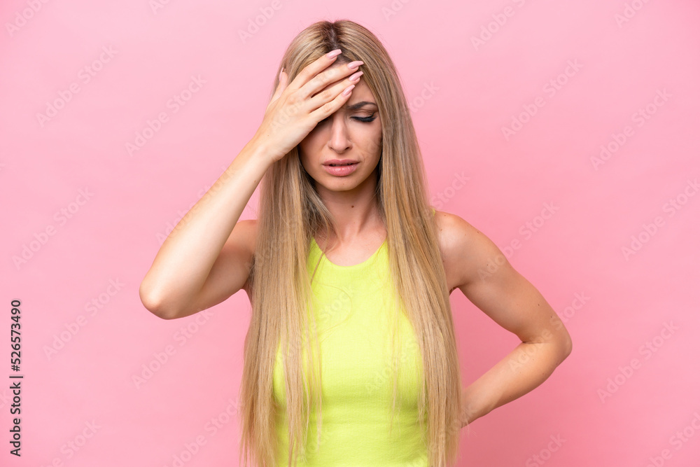 Pretty blonde woman isolated on pink background with headache Pretty blonde woman isolated on pink background with headache