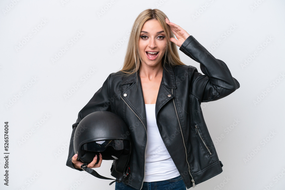 Pretty blonde woman with a motorcycle helmet isolated on white background with surprise expression Pretty blonde woman with a motorcycle helmet isolated on white background with surprise expression