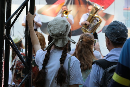 Photography A crowd of people watching a concert of a group of musicians performing outdoors