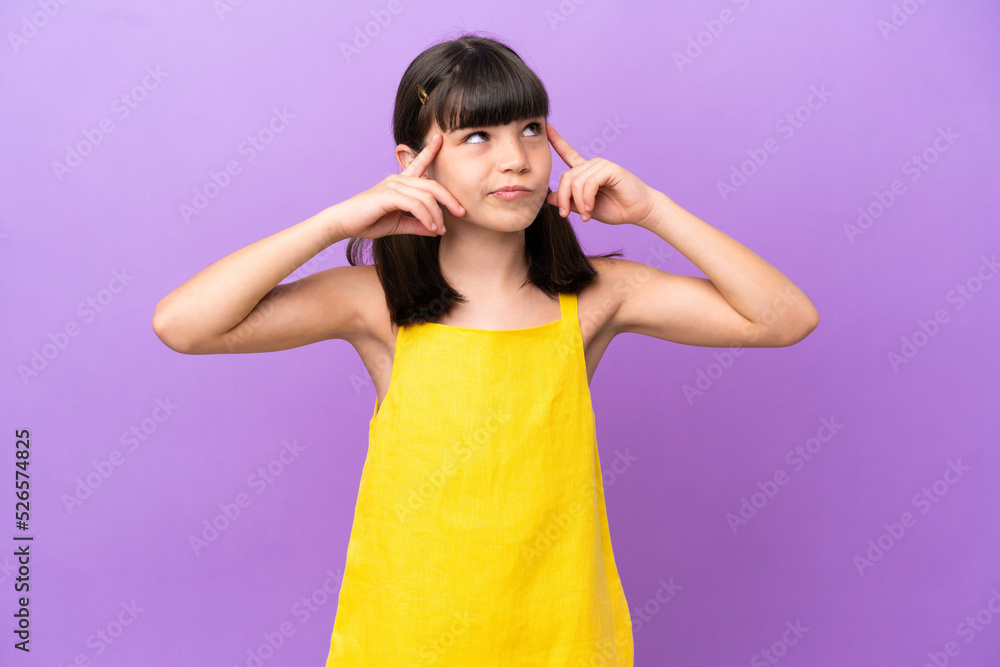 Little caucasian kid isolated on purple background having doubts and thinking Little caucasian kid isolated on purple background having doubts and thinking