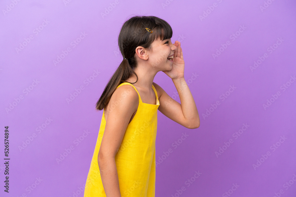 Little caucasian kid isolated on purple background shouting with mouth wide open to the side