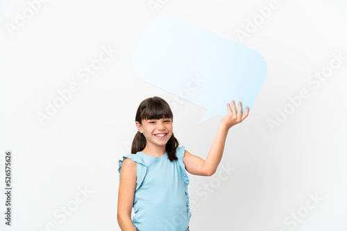 Little caucasian kid isolated on white background holding an empty speech bubble