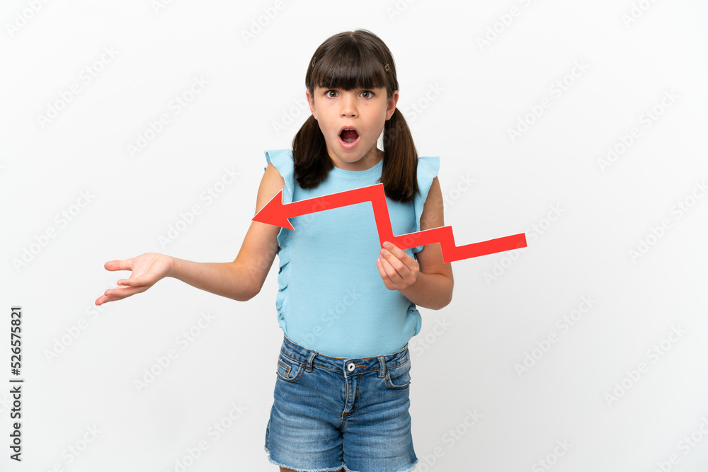 Little caucasian kid isolated on white background holding a downward arrow and with sad expression Little caucasian kid isolated on white background holding a downward arrow and with sad expression