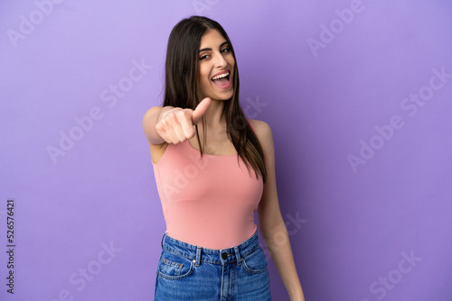 Young caucasian woman isolated on purple background with thumbs up because something good has happened