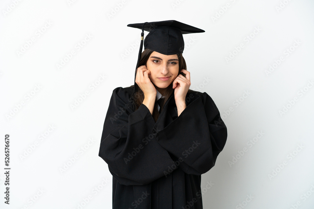 Young university graduate isolated on white background frustrated and covering ears Young university graduate isolated on white background frustrated and covering ears