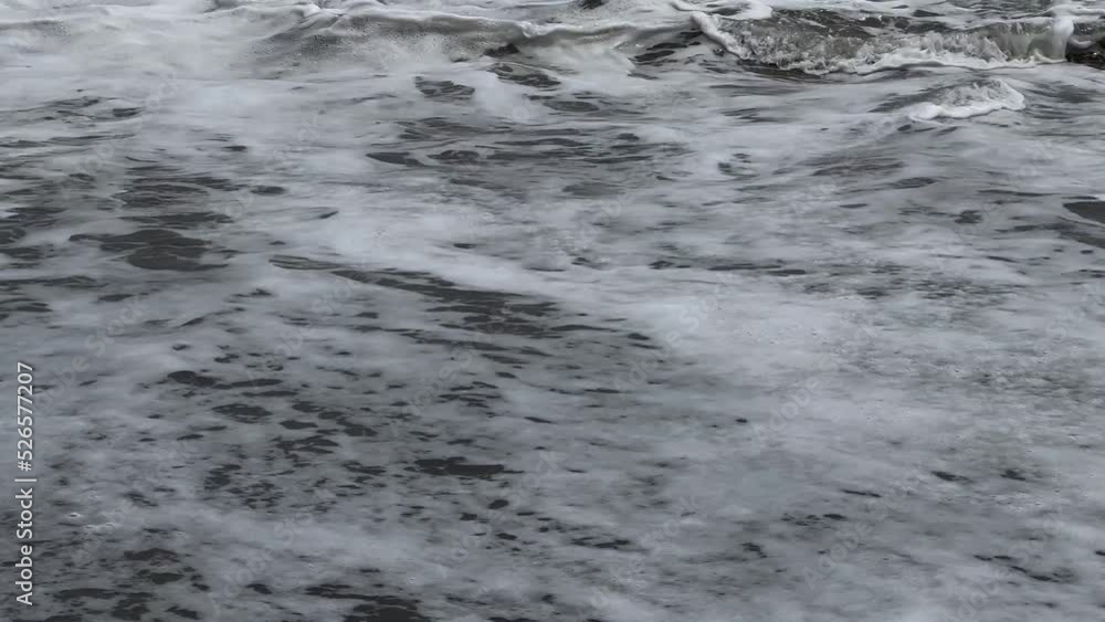 Low angle of the seashore with strong waves near the shore