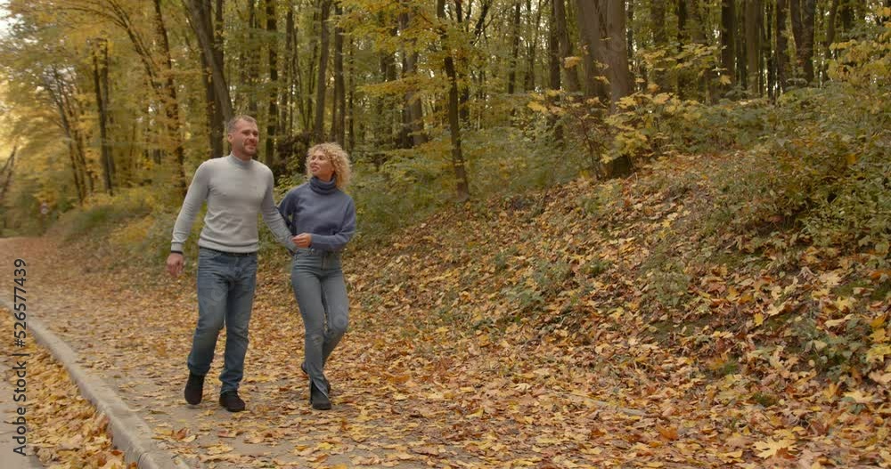 Loving couple in jeans on a date in the autumn park Loving couple in jeans on a date in the autumn park