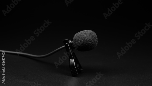 small lavalier microphone close-up on a black background