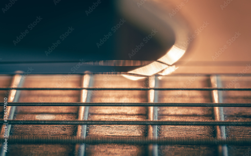 Obraz premium Strings on a classical acoustic guitar, macro shot.