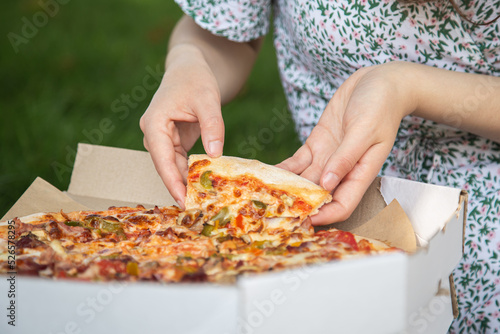 Piece of pizza close-up, concept of picnic and relaxation.