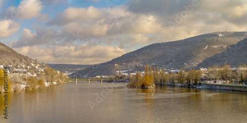 Winter with snow in old downtown, castle and main city bridge in Heidelberg, Germany, with blue cloudy sky and sunny day, panorama
