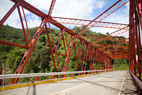 Steel structure bridge close-up. Concrete road and bridge with red beams. Road bridge design. Road in the Philippines.
