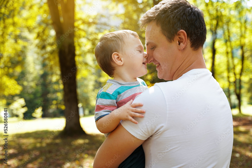 Dad plays with his little son in the park outdoors. Family pastime. Happy smiling people. Boy of one and a half years. Toddler. Selective focus Dad plays with his little son in the park outdoors. Family pastime. Happy smiling people. Boy of one and a half years. Toddler. Selective focus