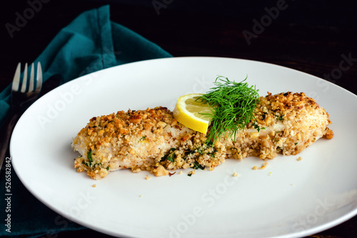 Canvas Print Walnut-Crusted Halibut in Lemon Wine Sauce Viewed from the Side: Baked white fis
