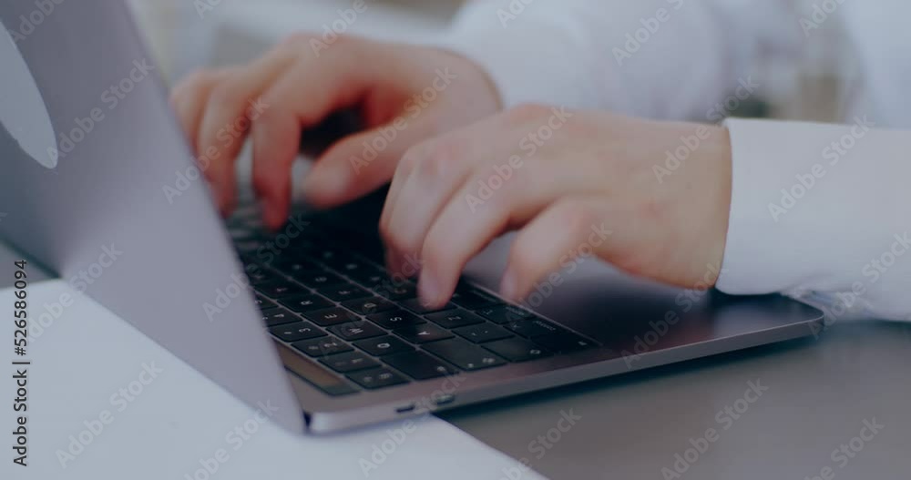 Man typing on keyboard laptop computer in office Man typing on keyboard laptop computer in office
