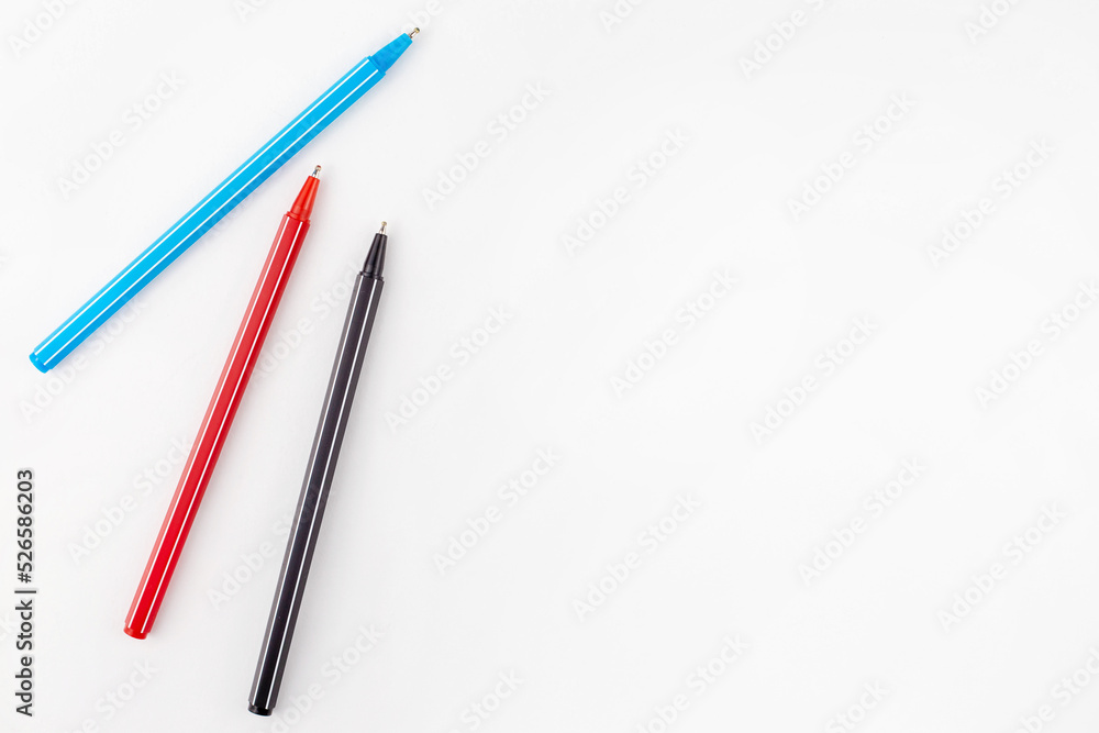Colored pens lie on a white background concept. Education. Background. School. Isolated Colored pens lie on a white background concept. Education. Background. School. Isolated