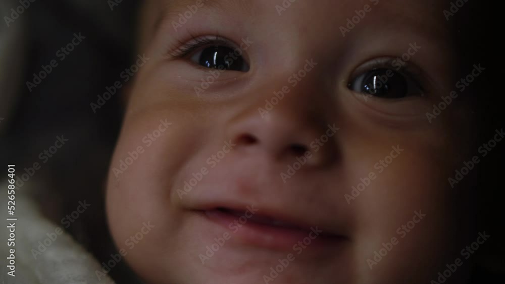 Baby boy sucks nipple at Evening. Smiling portrait of little child. Happy Family. Close-up sleepy Face of Child Eyes While looking at the camera in the dark. Infant, Childhood, Childcare, Motherhood Baby boy sucks nipple at Evening. Smiling portrait of little child. Happy Family. Close-up sleepy Face of Child Eyes While looking at the camera in the dark. Infant, Childhood, Childcare, Motherhood