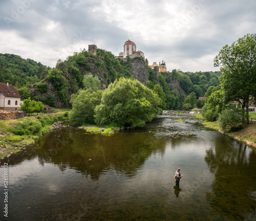 Vranov nad Dyji castle from below in the background and a fisherman in the foreground photo