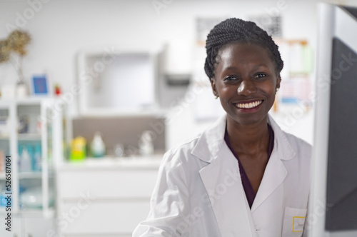 Young medical officer smilling next to her work space