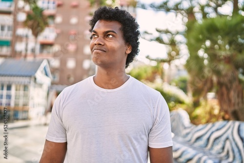 Young south east man smiling confident walking at street