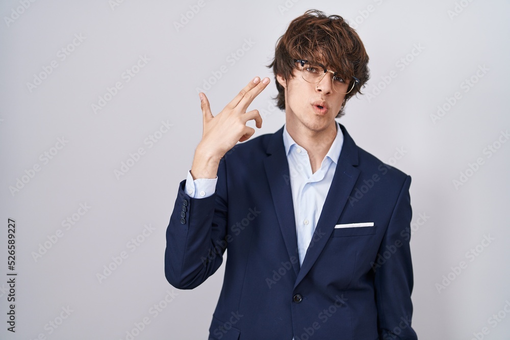 Hispanic business young man wearing glasses shooting and killing oneself pointing hand and fingers to head like gun, suicide gesture. Hispanic business young man wearing glasses shooting and killing oneself pointing hand and fingers to head like gun, suicide gesture.