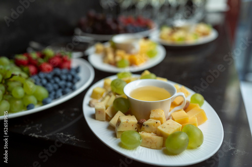 plate with cheese assortment with honey and nuts