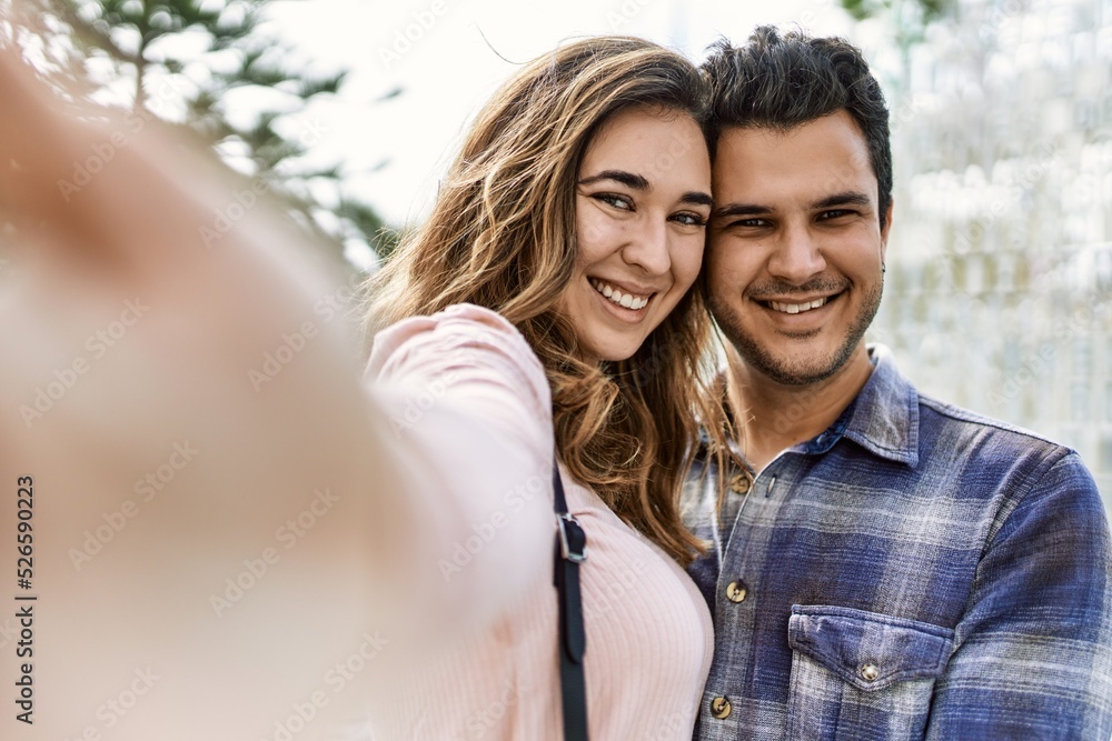 Young hispanic couple hugging in love at the city. Girlfriend and boyfriend together in love taking selfie picture Young hispanic couple hugging in love at the city. Girlfriend and boyfriend together in love taking selfie picture