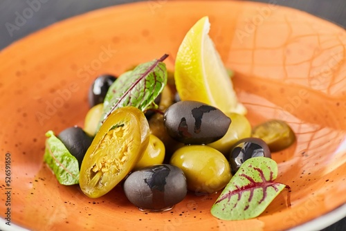 Olives and olives with lemon and salted vegetables. Serving dishes at the restaurant.