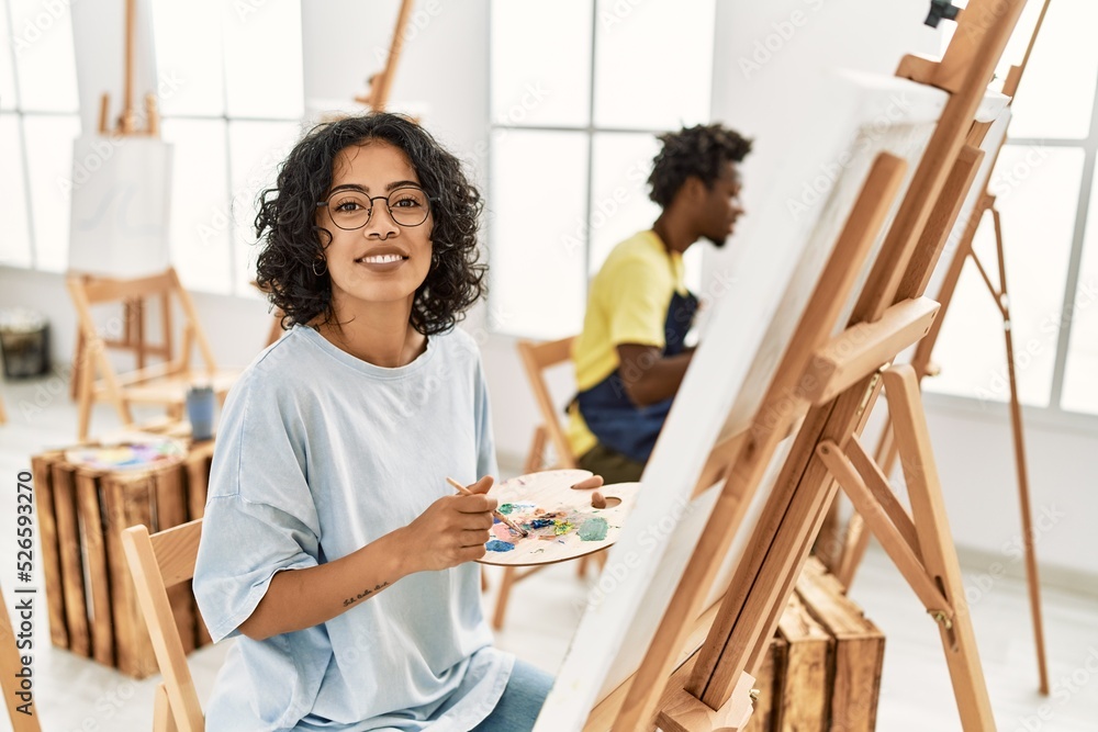 African american artist couple smiling happy painting at art studio. African american artist couple smiling happy painting at art studio.