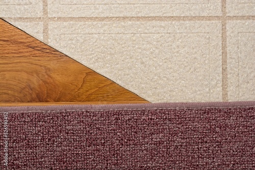 Fotografie Juncture of oak hardwood vinyl and carpet floor covering.