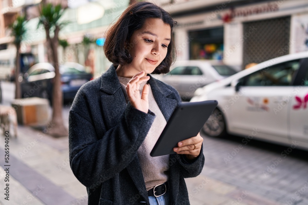 Young woman smiling confident using touchpad at street Young woman smiling confident using touchpad at street