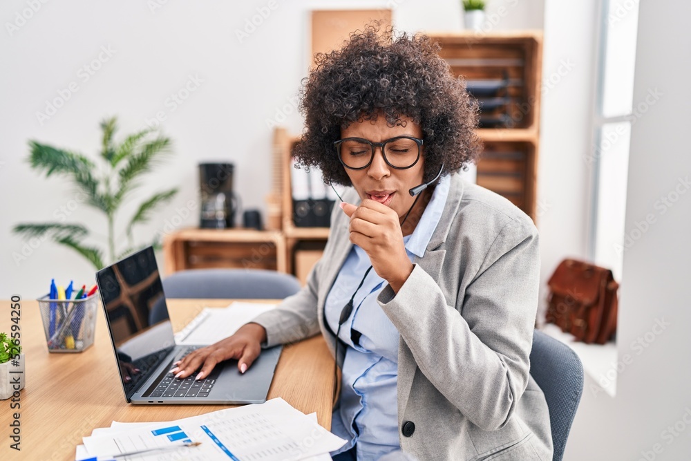 Black woman with curly hair wearing call center agent headset at the office feeling unwell and coughing as symptom for cold or bronchitis. health care concept. Black woman with curly hair wearing call center agent headset at the office feeling unwell and coughing as symptom for cold or bronchitis. health care concept.