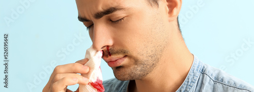 Young man with nosebleed on...