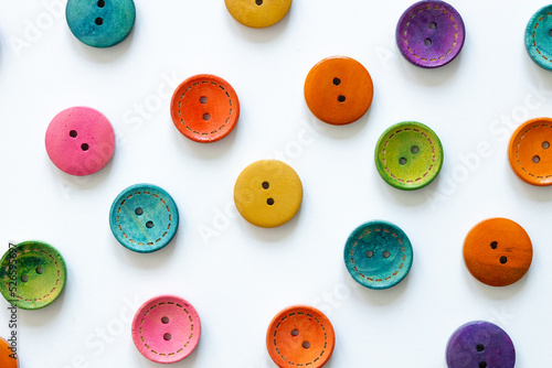 Frame of colorful sewing buttons isolated on white photo