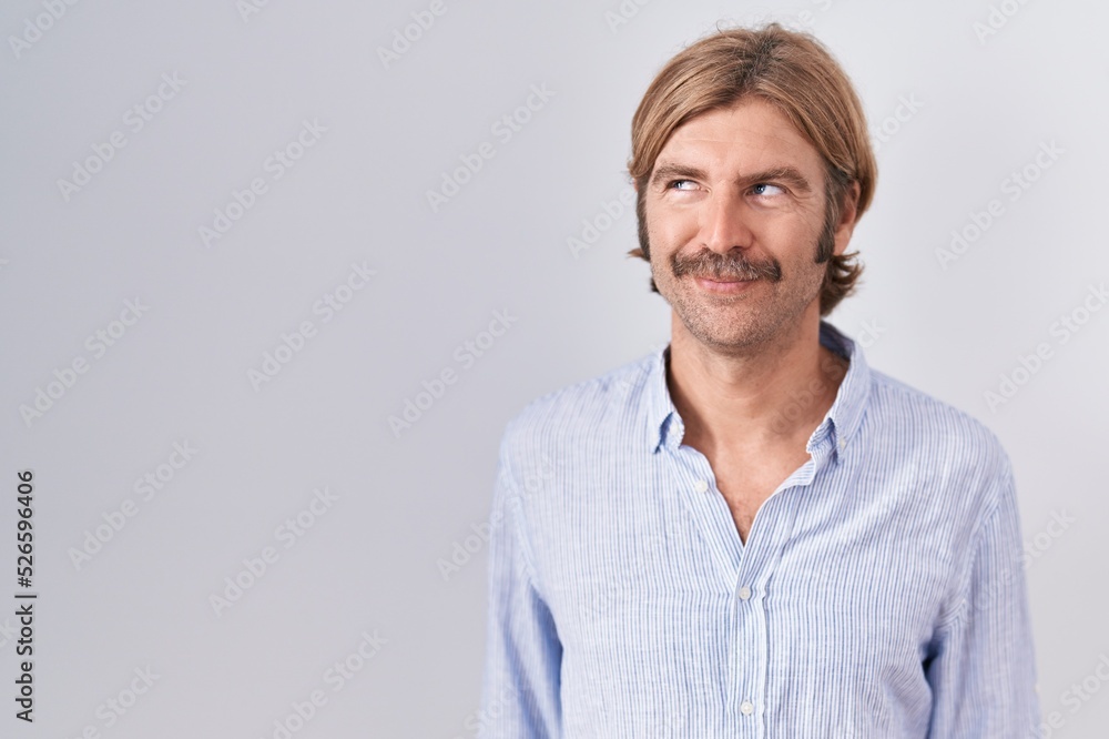 Caucasian man with mustache standing over white background smiling looking to the side and staring away thinking. Caucasian man with mustache standing over white background smiling looking to the side and staring away thinking.