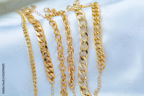 Gold  jewelry. Gold chains on background