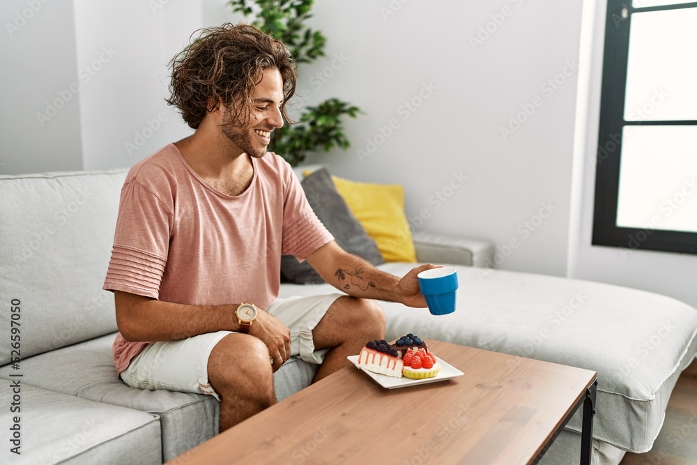 Young hispanic man having breakfast sitting on the sofa at home. Young hispanic man having breakfast sitting on the sofa at home.