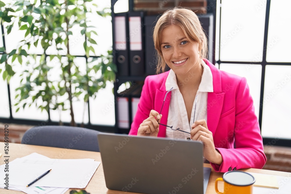 Young blonde girl business worker using laptop working at office Young blonde girl business worker using laptop working at office