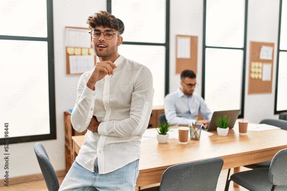 Two hispanic men business workers standing with arms crossed gesture at office Two hispanic men business workers standing with arms crossed gesture at office