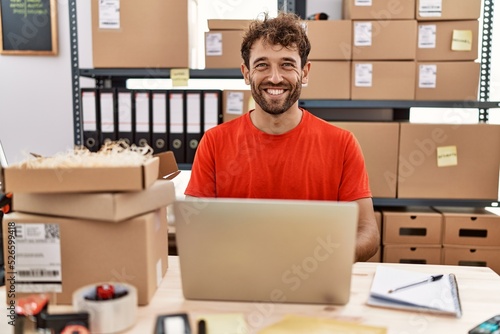 Young hispanic man smiling confident working at storehouse