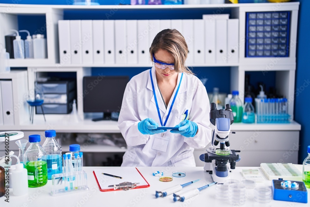 Young woman scientist make photo to pills at laboratory Young woman scientist make photo to pills at laboratory