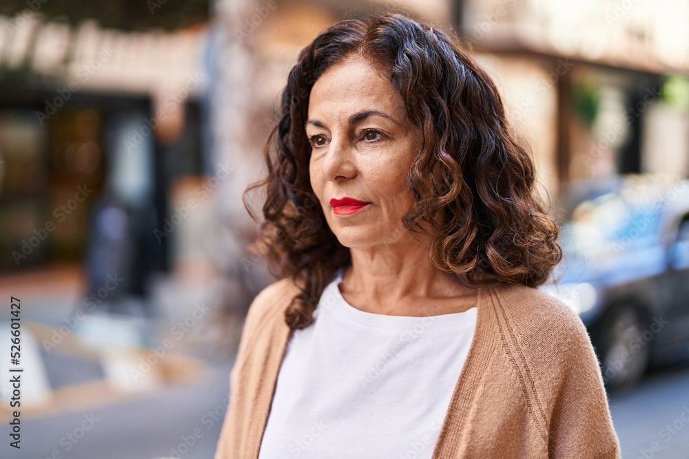 Middle age hispanic woman looking serious outdoors Middle age hispanic woman looking serious outdoors