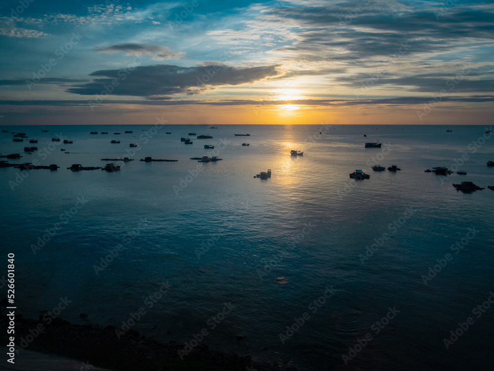 Beautiful top view of the sea at sunset with fisher boats in Vietnam