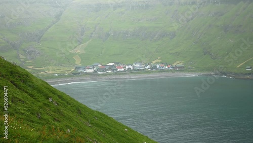 Faroese village of Tjornuvik. Old faroese houses in the middle of mist faroese nature. Typical old house in Faroe Islands with a Grass rooftop. Grass covered house. High quality 4k footage.  photo