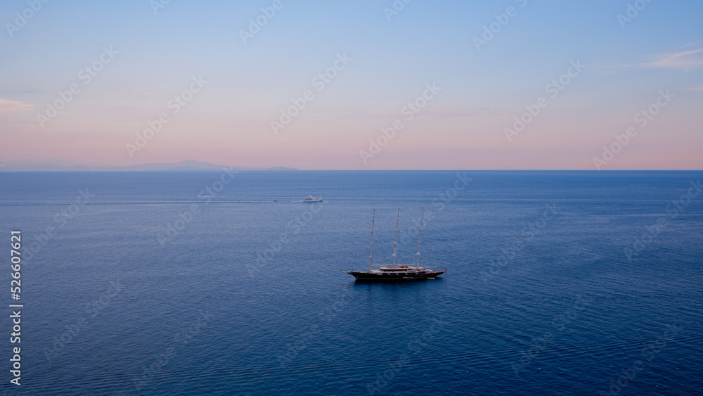 Fototapeta premium boat in the sea at sunset