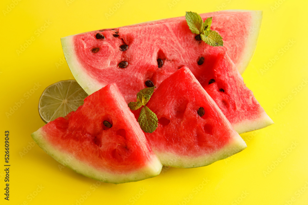 Slices of watermelon with mint on yellow background Slices of watermelon with mint on yellow background